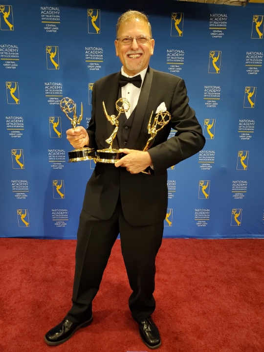 Len Brown holding Emmy Awards