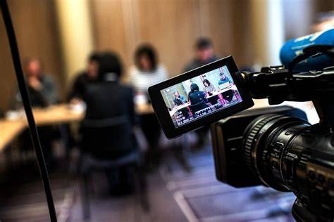 Camera filming corporate meeting